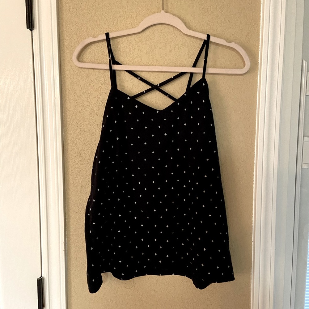 Black criss cross tank with white + on it